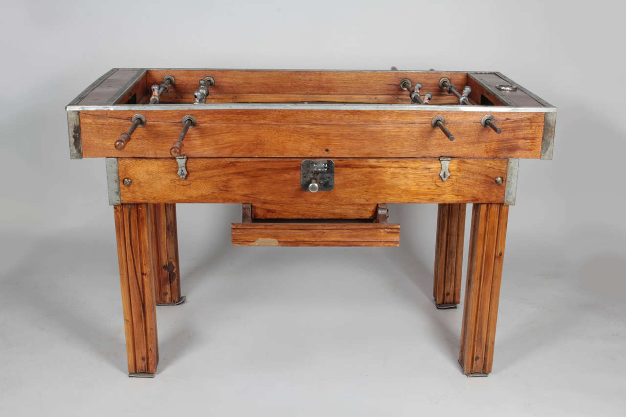 Rare 1950s-era, two-person foosball table by Portuguese billiards company Bilhares Triunfo. Paint wear on all six field players. One silver disc missing on the top of one side. Original ball included. As this was used for decorative purposes, we