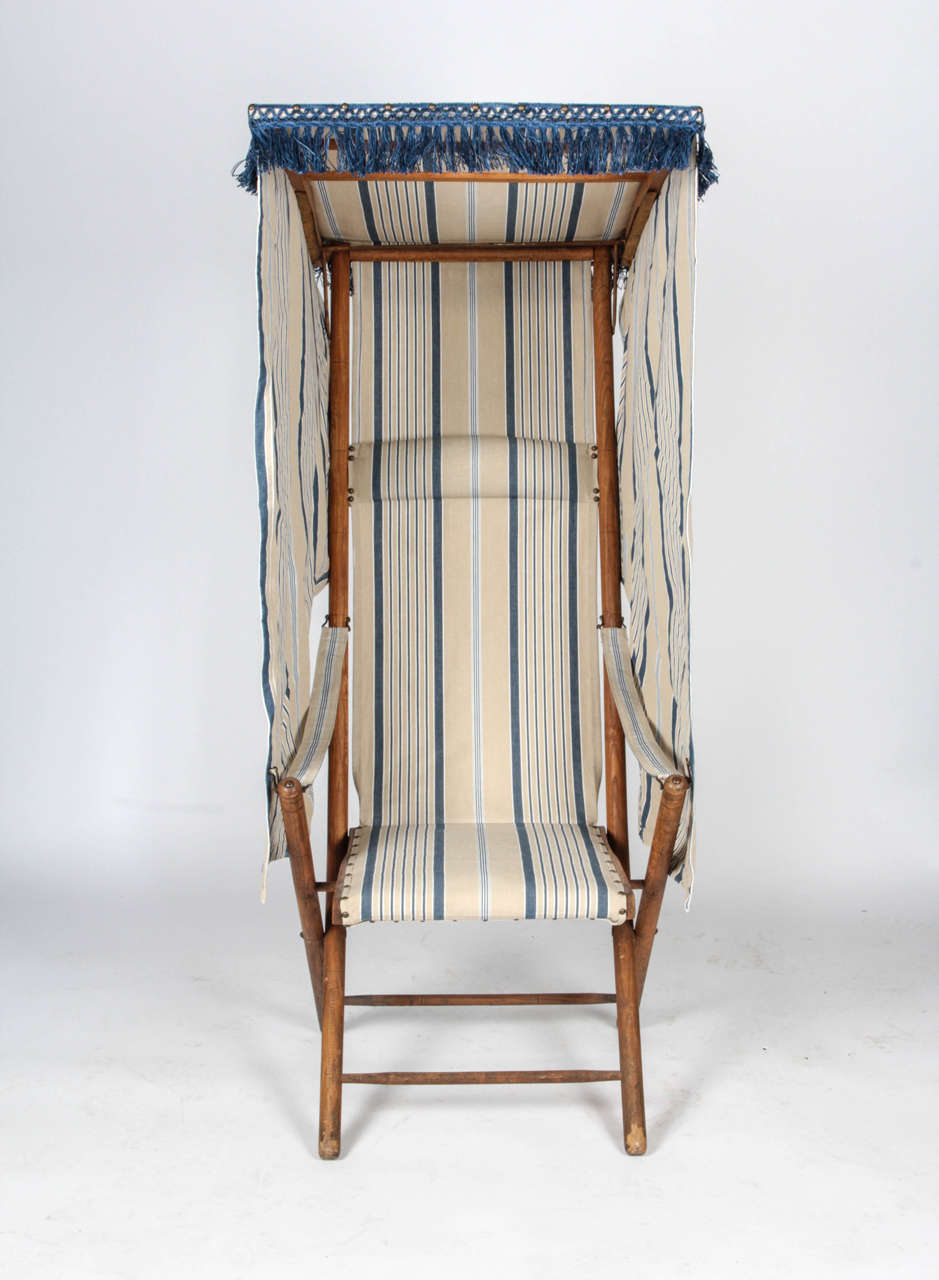 Early 20th century beach chair. Folds flat. Recently reupholstered.

Not available for sale or to ship in the state of California.