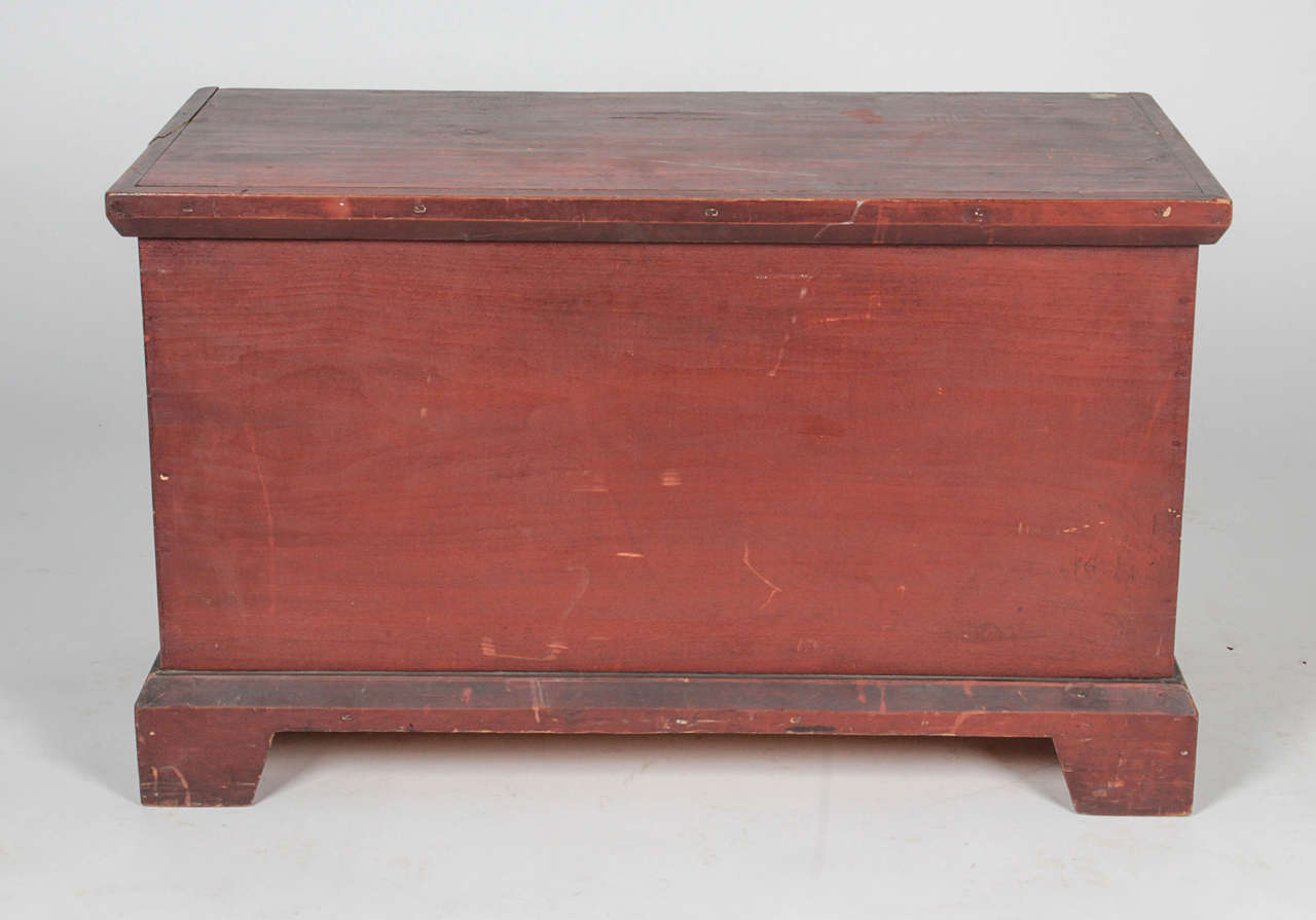 Great antique pine trunk or chest to store your blankets or oddities. Covered interior compartment to store smaller items and to prop chest open. Worn red paint has scratches consistent with age. Back of chest is unpainted.

*Not available for