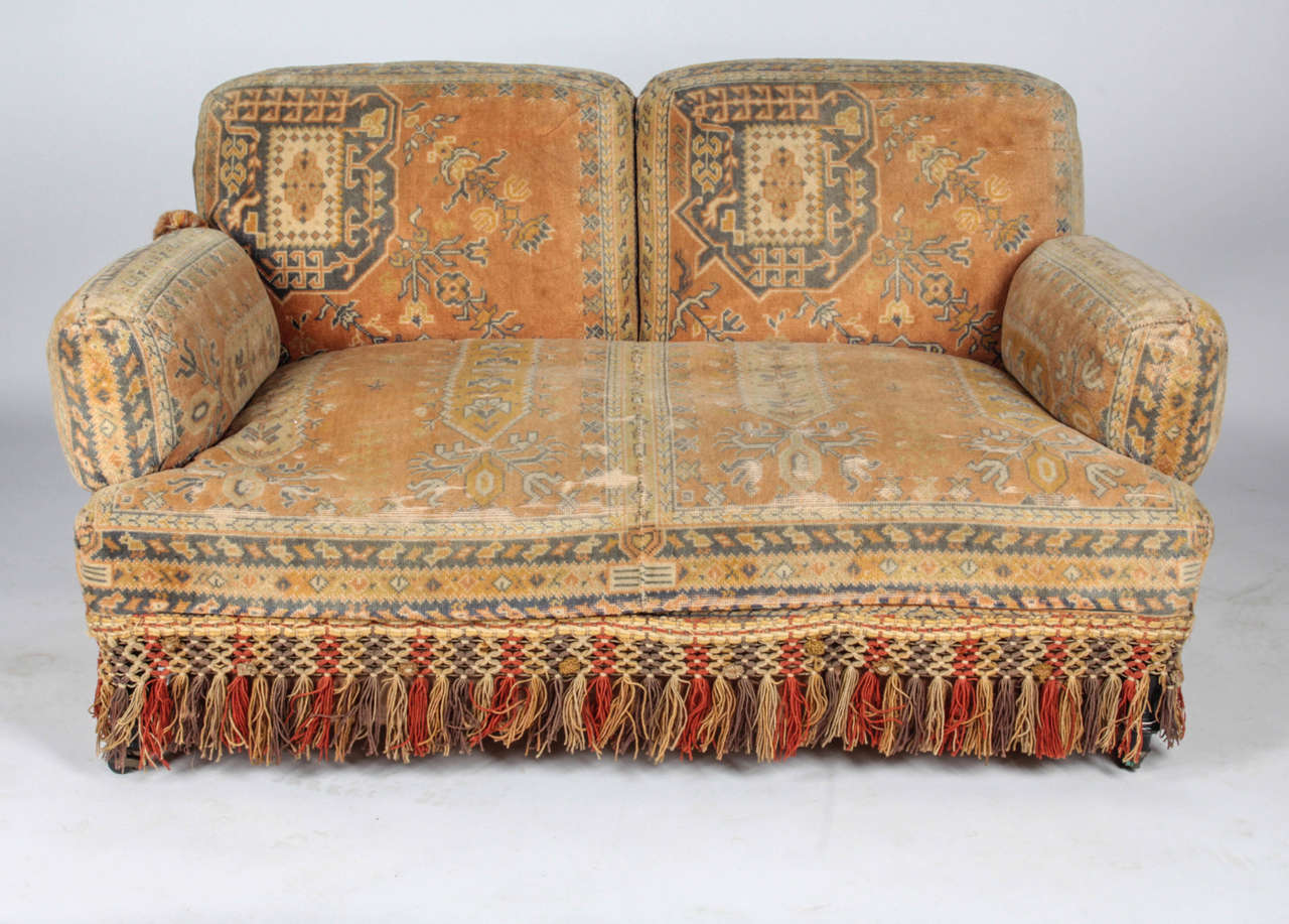 This Bohemian seating set includes a sofa or loveseat, an armless side chair, and a matching club chair. Purchased in Paris, this complete set is a rare find.

Turned wood legs are completed with brass wheels. The cushion of the sofa or loveseat