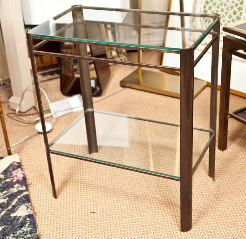Simple & modern brass based end table with 2 shelves of thick glass.