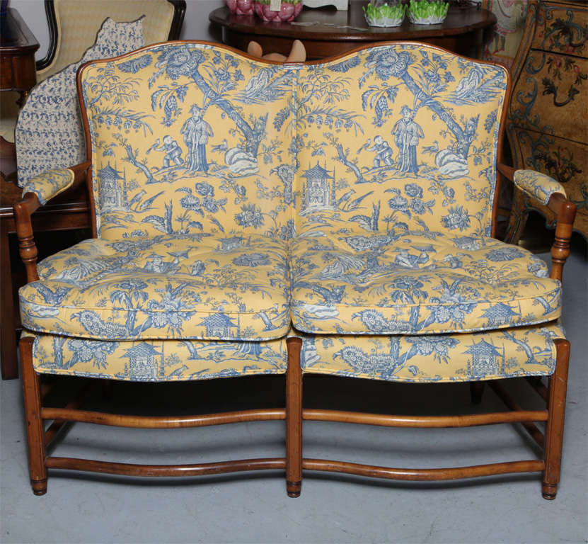 Lovely country french loveseat, newly upholstered in toile and check fabrics.