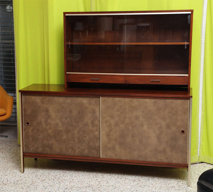 REDUCED FROM $4,250.
Paul McCobb's mastery of no-nonsense design reigns in this beautifully designed and figured walnut server sideboard with removable top cabinet. Produced by Calvin, it has elements of the linear line with metal trim on the front