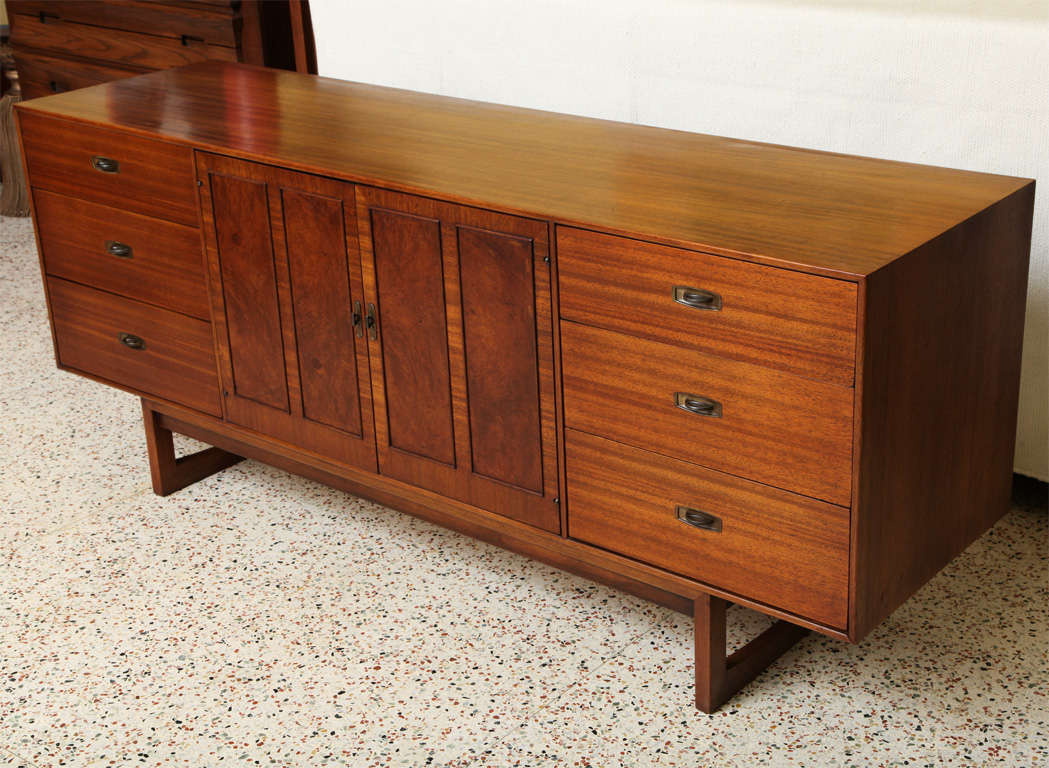 SOLD OCT 2012 Exhibiting rich warm woods, this mahogany & burl nine drawer dresser has sleek mid century styling and beauty. Featuring three drawers left and right separated by two burl doors opening to three wide shallow front drawers.  Richly