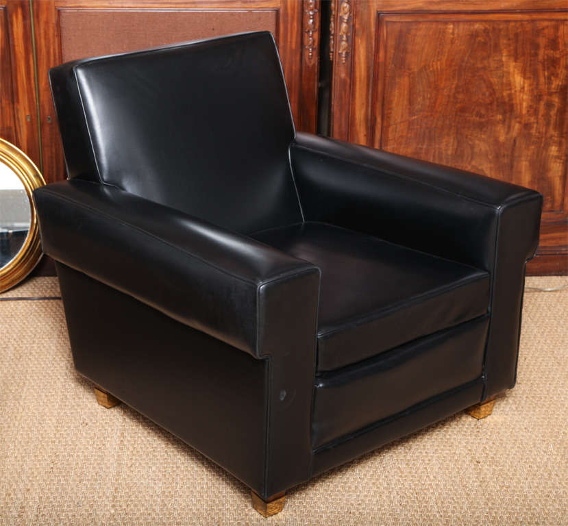 Armchairs by Erton, upholstered in super soft black leatherette (original), with mahogany legs and brass square sabots. These chairs are super comfortable!

Retains manufactured metal label underneath.