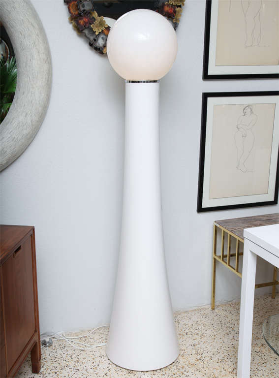 This fabulous 60's Italian floor lamp by Gae Aulenti would be right at home on the set of Stanley Kubrick's A Clockwork Orange, but we see it in a much more hospitable environment (preferably seaside). A white lacquered, fiberglass base tapers up to