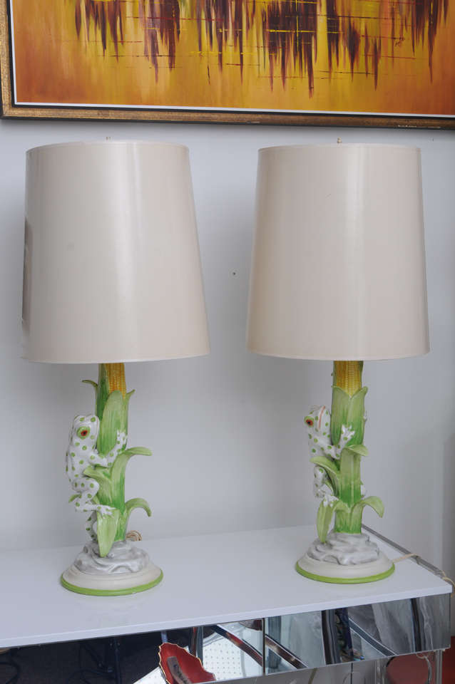 Hand-painted ceramic yellow and green spotted frog makes its way up the cornstalk in these light-hearted table lamps.  Vintage gloss paper shades included.