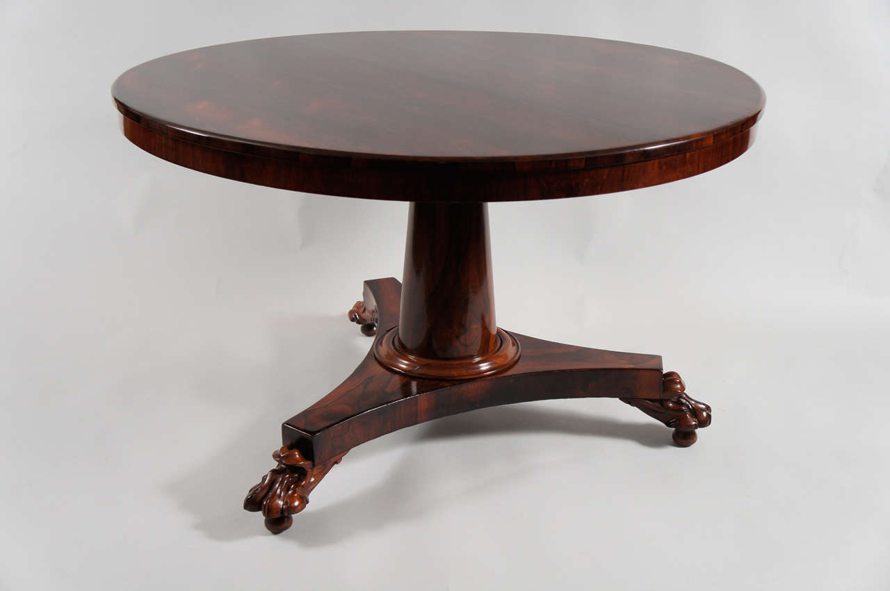 Regency rosewood centre table with paw feet.