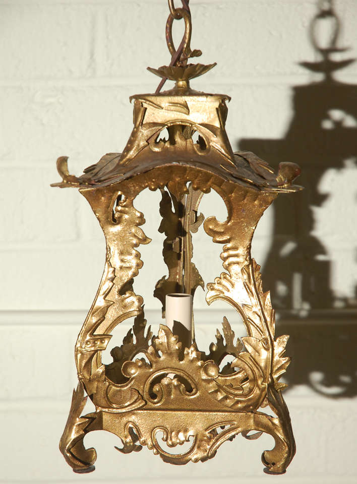 Venetian style pair of restored tole hanging lantern pendants.
Gilt metal. Measurements are of fixture approx 3'chain with canopy. New electrical with candelabra base.
See last two photos for more subdued coloration as main photography used flash.