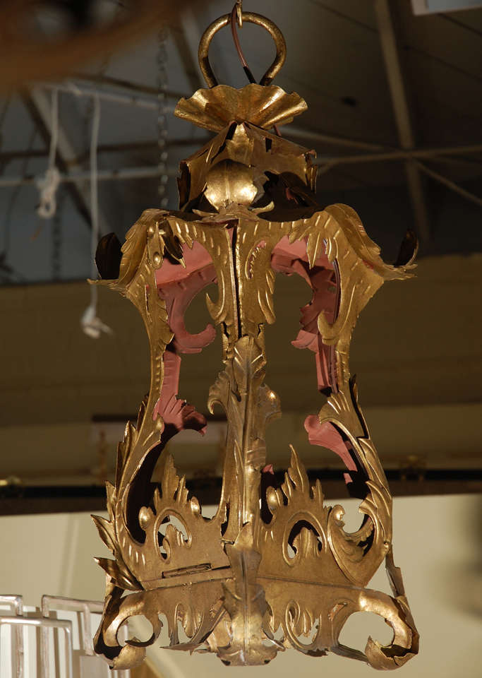 Restored larger Venetian style tole hanging lantern pendant.
Gilt metal. Measurements are of fixture approx 3'chain with canopy. New electrical with candelabra base.
See remaining photo for more accurate coloration as main images used flash.