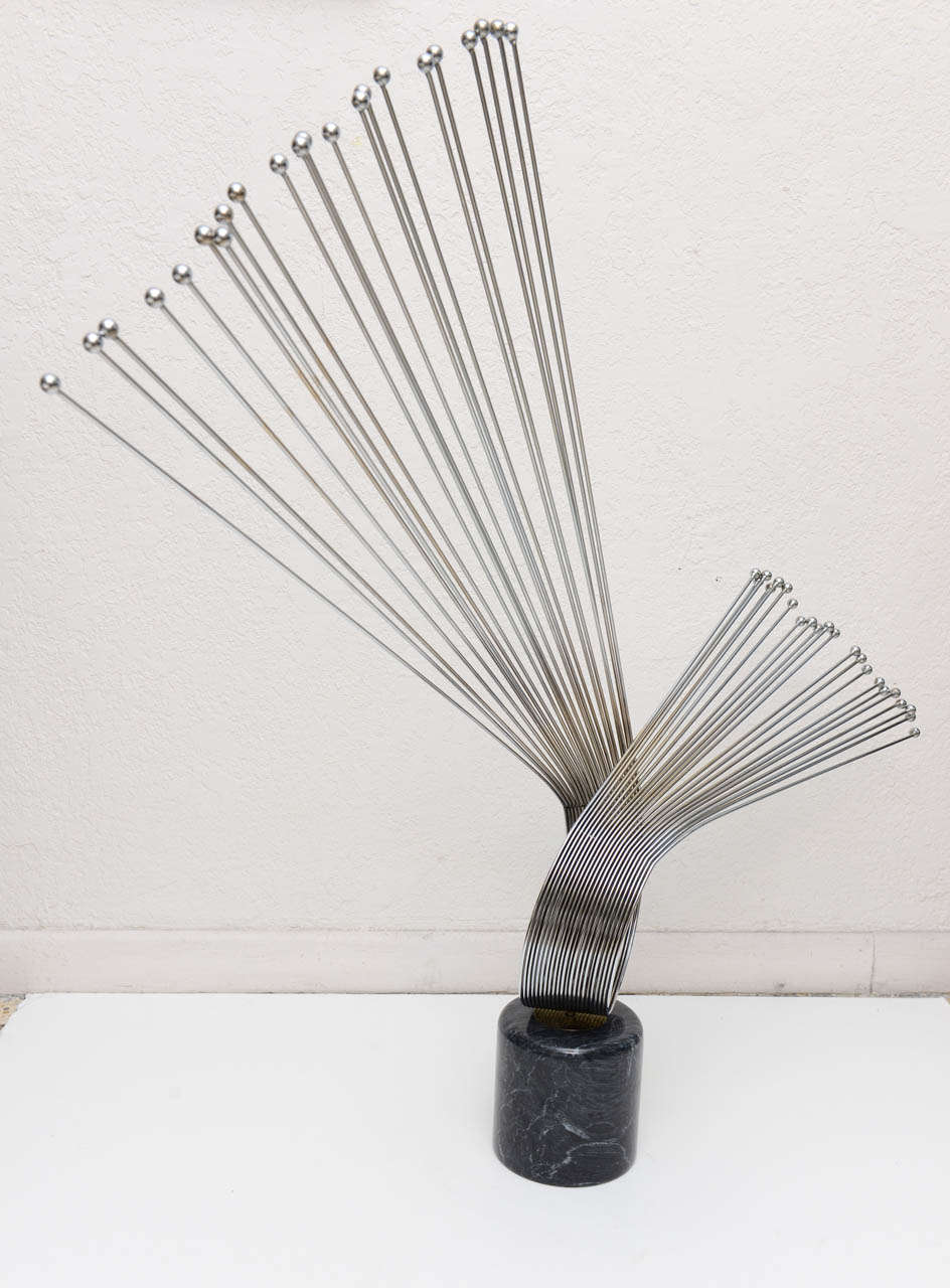 Curtis Jere (signed) tabletop sculpture. A dramatic spray of metal rods inserted into a black marble base. Base measures 6" high x 6" diameter. 

Please feel free to contact us directly for a shipping quote or any additional information