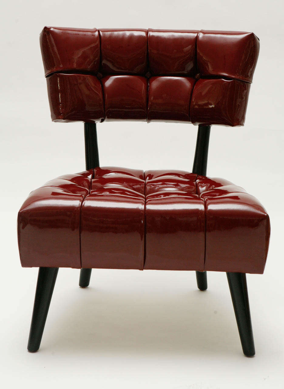 A stunning pair of biscuit-tufted hostess chairs, newly upholstered in a beautiful red patent leather. The chairs were custom designed by William Haines for the Beverly Hills home of Myron Prinzmetal.