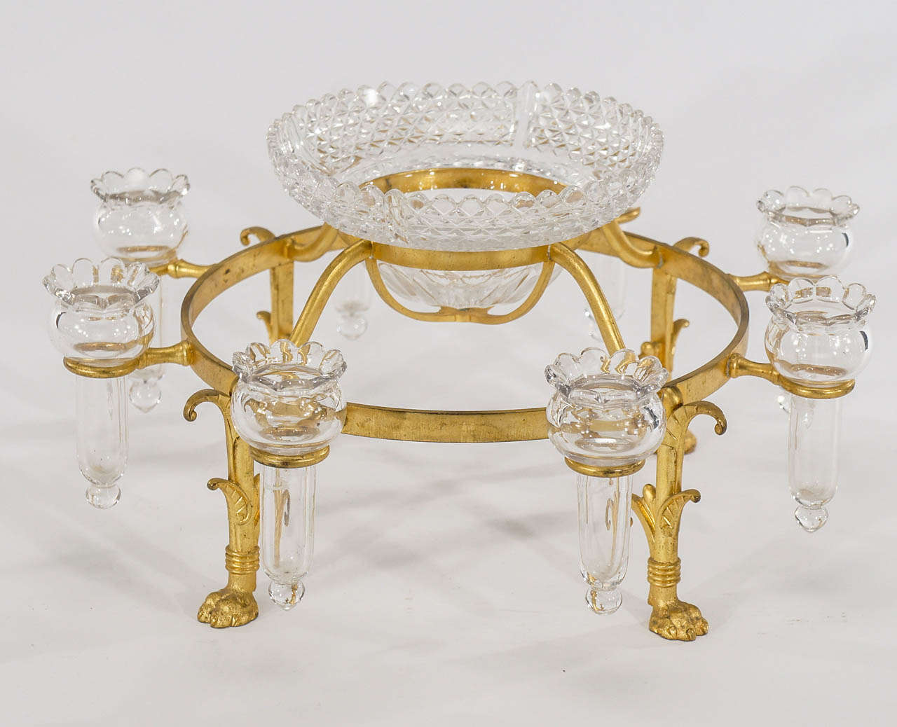 A superb example of an Osler centerpiece with all the bells and whistles. The gold vermeil finish on the footed mount sets off the beautiful cut crystal bowl with undulating rim is surrounded by 8 matching hand blown crystal trumpets which are ready