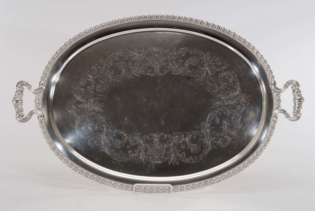 This is not your typical tray- It is beautifully made with chased and engraved decoration, an unobtrusive monogram and in overall excellent condition with no copper showing. The extra large size and flat bottom makes it a perfect tray for using on