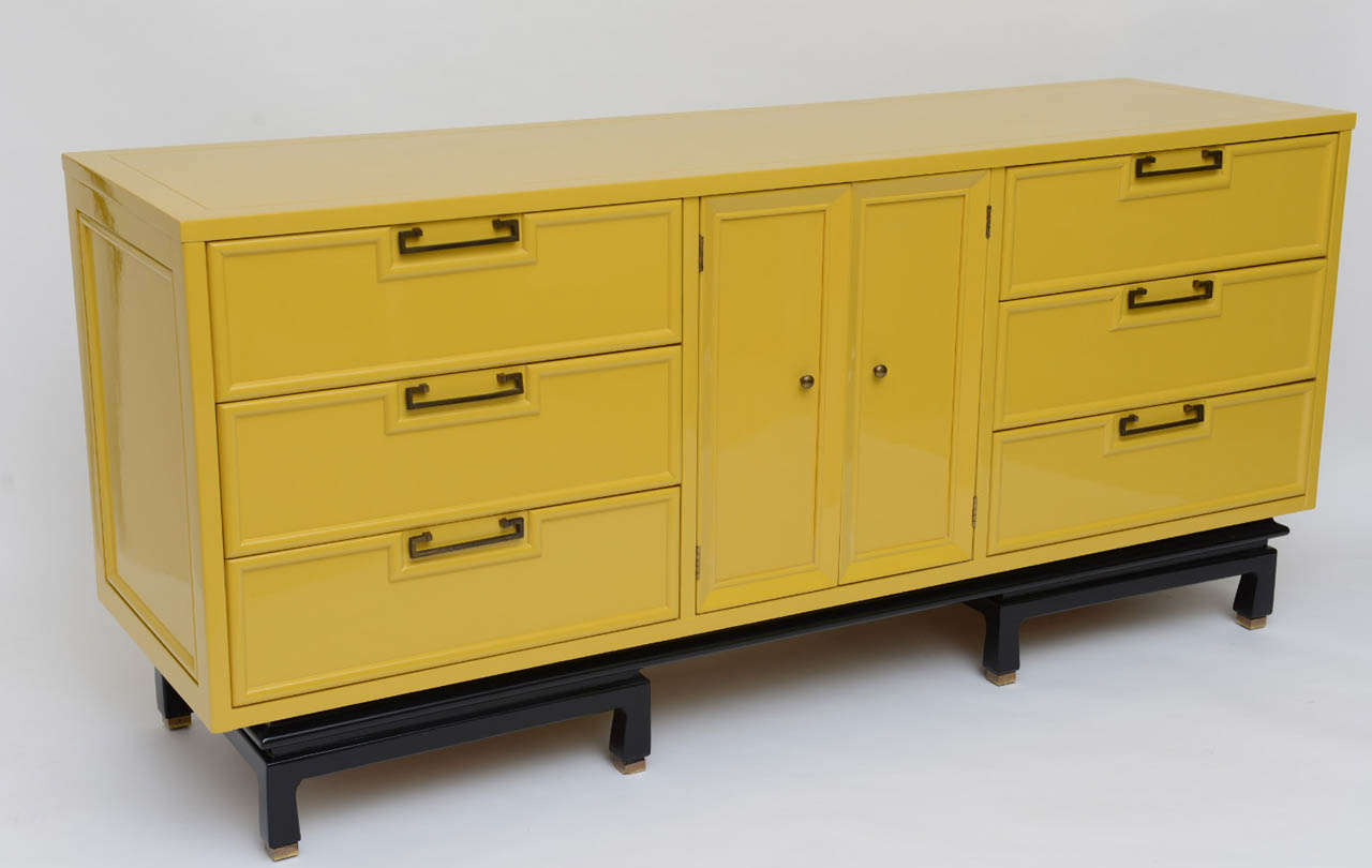 SOLD  Beautifully  lacquered a gloss mustard, this wonderfully detailed nine drawer dresser by American of Martinsville in the Asian Oriental taste is quite elegant with lots of storage.  Featuring six full size drawers and three short drawers