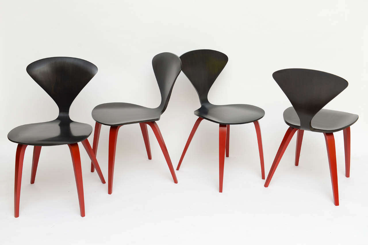 SOLD  Sculptural and beautiful seemingly alien-like life forms, this set of four Cherner style chairs have an ebonized finish on the walnut bodies and chinese red lacquered legs providing a special kick.  Price is for the set of four.
Side chairs,