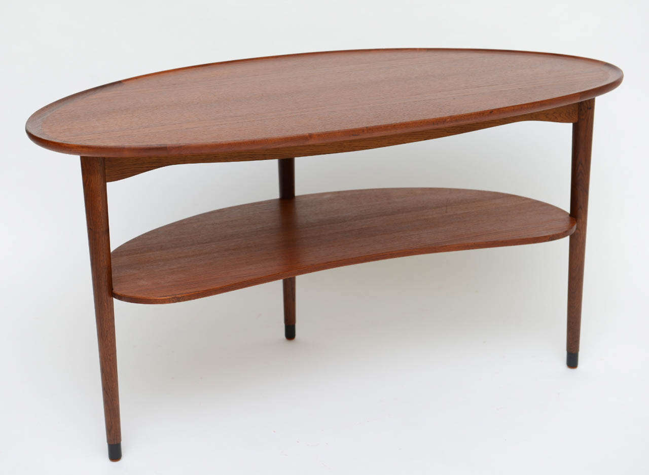 Exceptional craftsmanship and quality in this 1950s Wegner style teak kidney shaped two tier table with scalloped edge.  Coffee table, end table or side table, it is definitely a versatile occasional table.  

Measurements:
42 3/4