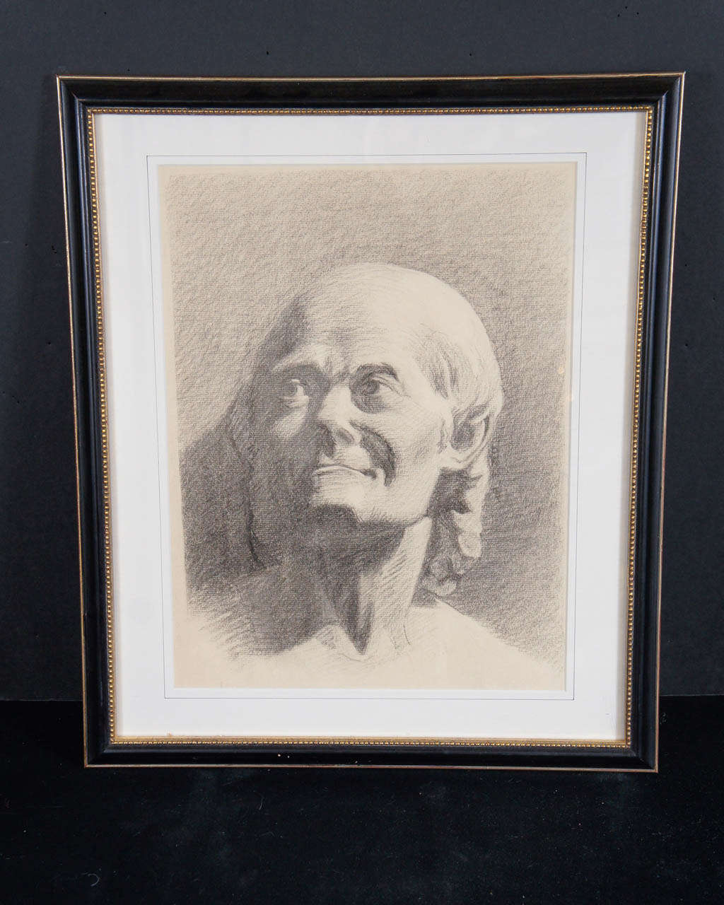 This finely rendered work showing  Francois-Marie Arouet also know as Voltaire is from the late 19th century. The drawing in a vintage frame shows the sitter in a somewhat relaxed pose and is probably taken from one of two versions of the famous
