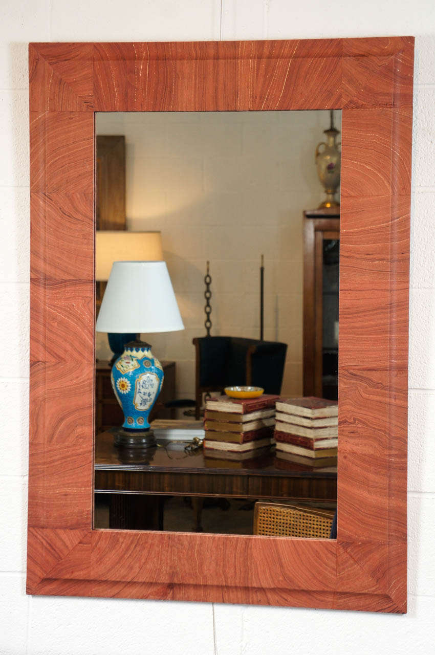 Here is a beautiful mirror decoupaged in a marbleized paper.
The block repeat pattern has a faux bois appearance.
The frame is reclaimed wood.