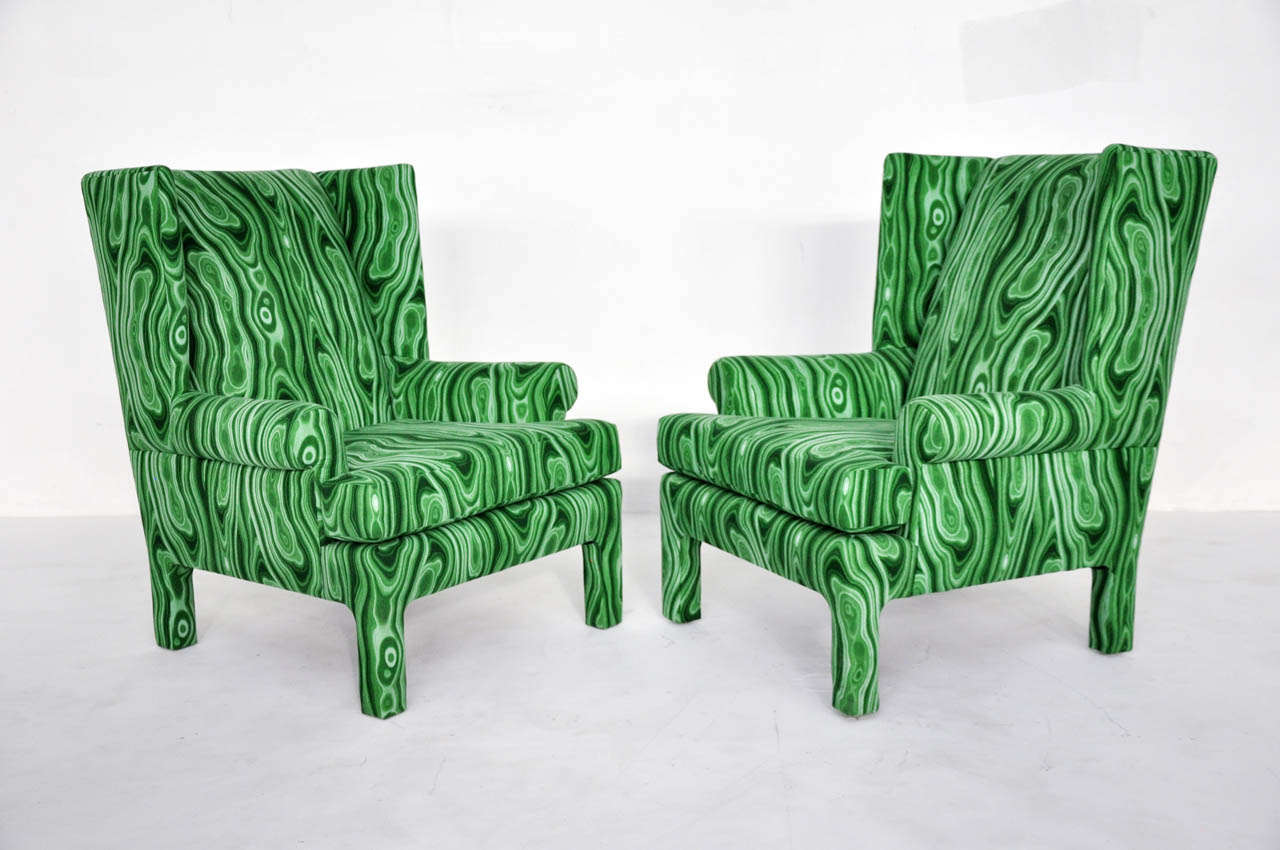 Dramatic wingback chairs newly upholstered in vibrant malachite fabric.