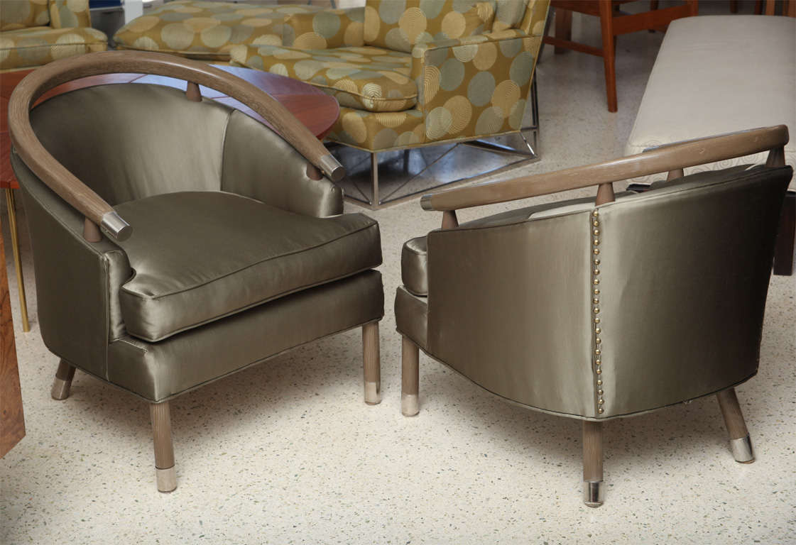 The rounded back and legs in limed oak with polished nickel caps.