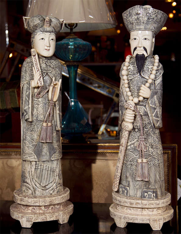 Pair of Chinese bone sculptures of female and male figurines. Exquisite carvings, each raised on double circular bases.