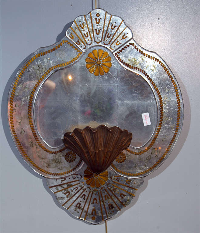 Pair of seashell form verre eglomise glass wall plaques, each decorated with a like seashell form bracket, attributed to Maison Jansen. We have two identical pairs available. 

Letter of authentication provided by James Archer Abbott, author of