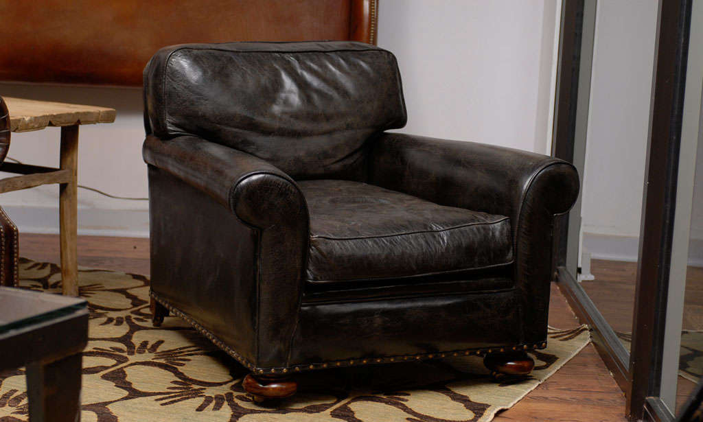 The chair is covered with an aged leather like a fine wine. It is a beautiful piece for anywhere, especially a library, living room, or den.