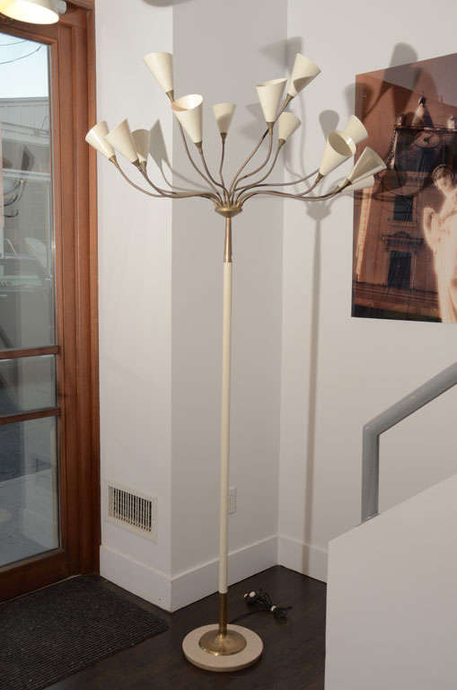 Italian floor lamp by G. Sarfatti for Arteluce.

13 flexible brass arms connected to brass pole standing on round marble base.