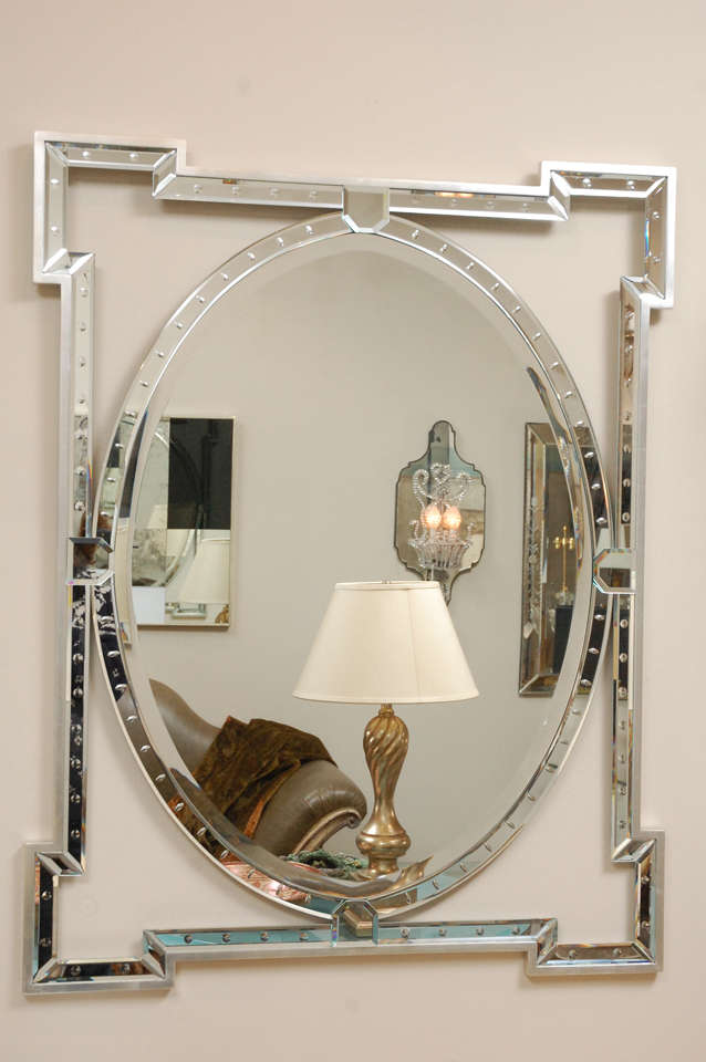 Made to Order Oval Banded mirror with silver leafed frame. Stepped-out corner, reverse carved ovals and spheres on mirror banding.
  