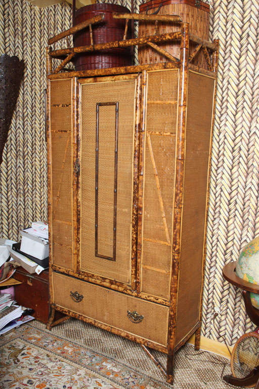 Very Handsome 20th Century English Bamboo Armoire with Rattan and 3 shelves. New grass cloth paper completes this old yet modern look.