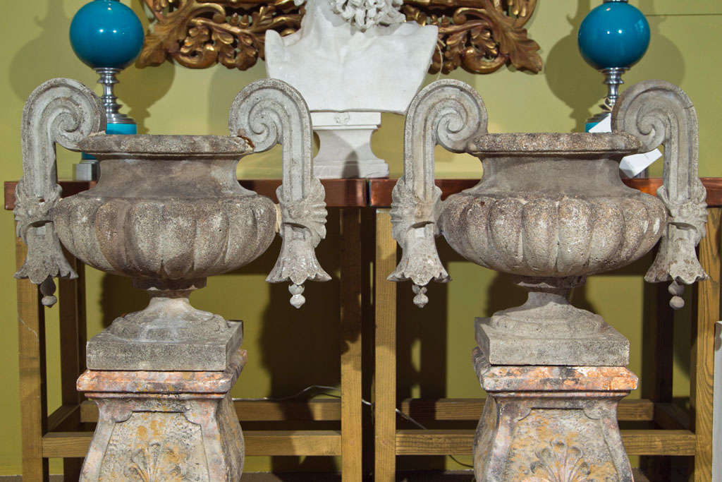 Gothic style urns with scroll form handles on square bases