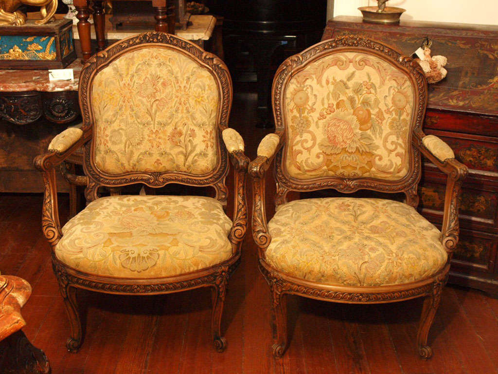 19TH CENTURY Italian walnut armchairs with needlepoint covering with slip seats and backs.