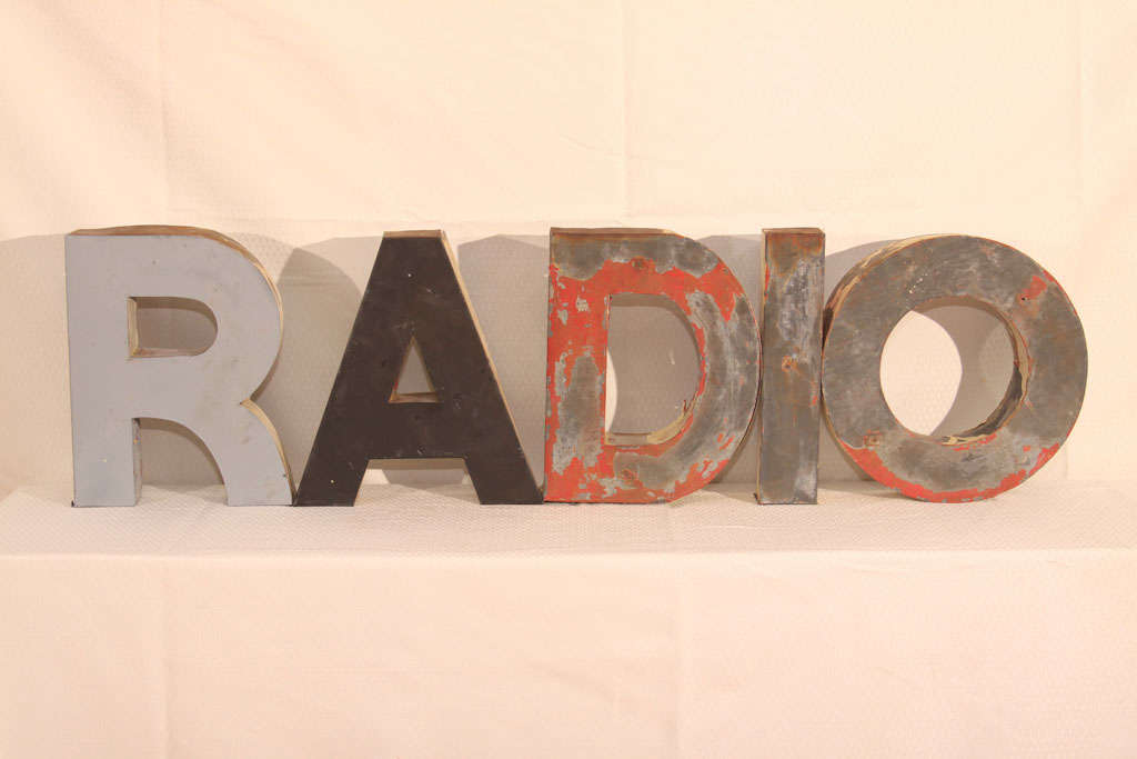 Five galvanized sheetmetal letters from an old small-town radio station.