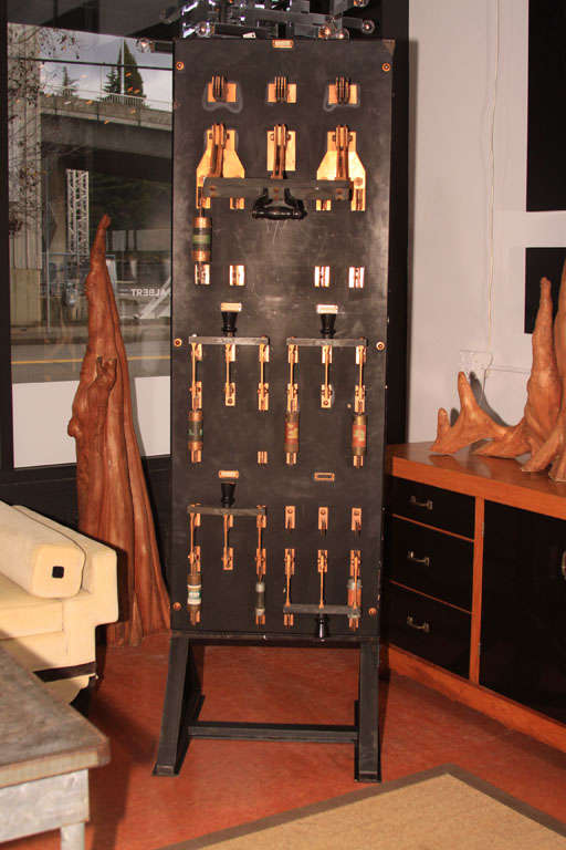 Heavy-gauge slate and copper old-style fuse panel on  a custom iron stand.
