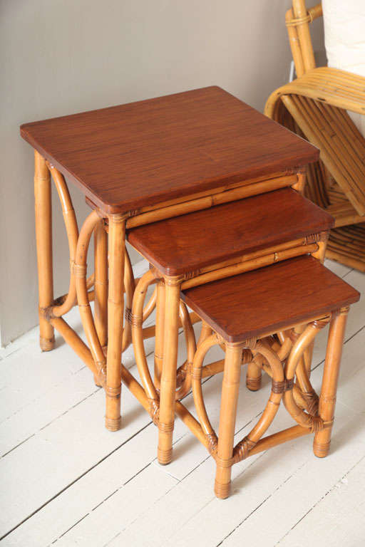 Set of 3 rattan nesting tables with mahogany tops by Kane Kraft.  Label.*Notes: There is no sales tax on this item if it is being shipped out of the state of Florida (Objects20c/Objects In The Loft will need a copy of the shipping document). Please