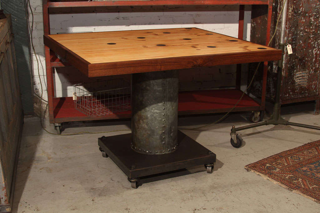 Maple, bowling alley pin deck, wrapped in walnut, with custom, riveted steel base.   Round repair plugs shown on surface of table, were applied through the years of use.  Outstanding for kitchen island, work table, or retail display.  Similar table