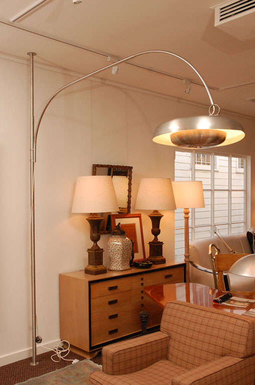 Large articulated floor-to-ceiling floor lamp designed by Pirro Cuniberti for Sirrah, Italy in 1970.

Chrome-plated aluminum, brushed metal, domed saucer lamp, and telescoping arm.  The pole mounts to the floor and ceiling, and the lamp arm is