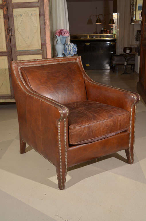 Leather armchair with brass nailheads.
