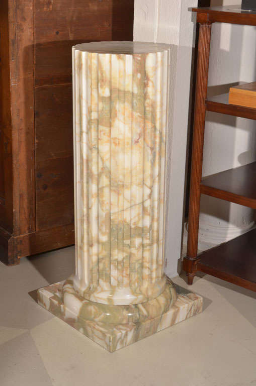 20th Century The fluted circular column supported by a square base