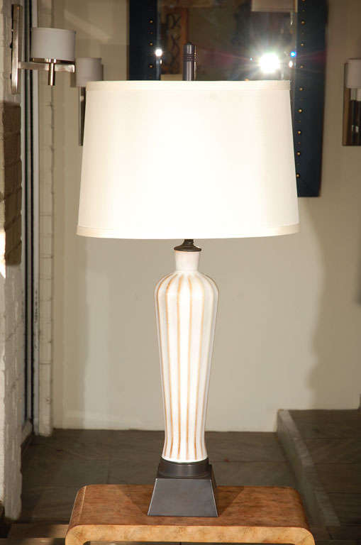 Early Mid-Century Danish table lamp in white and gold porcelain. Refinished base and finial, new electrical. Shade not included. Very faint scratch under glaze reverso probably from when made and hardly noticeable
