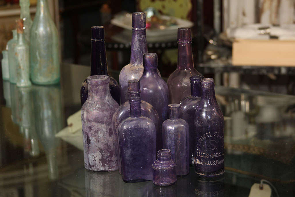 beautiful collection of 11 assorted bottles-  different sizes, shapes and original uses. These bottles started out clear, but the manganese in the glass turns them purple with age.