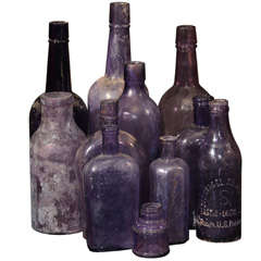 Antique collection of 11 purpling bottles