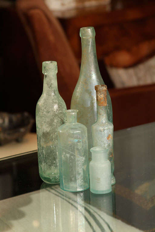 group antique bottles of varied size and shape- beautiful on shelf or on windowsill.  very pretty with flowers on bedside table