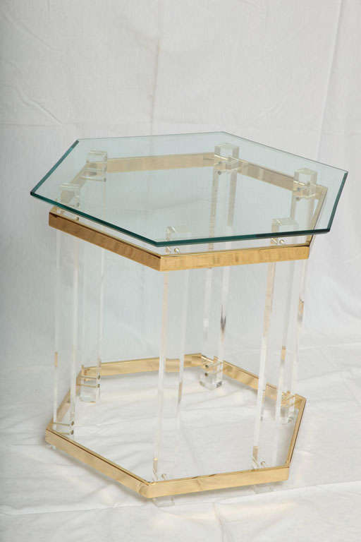 SOLD JULY 2011 Hexagonal in shape, this jewel-like table with six thick lucite legs is belted with two thick brass bands and nicely topped with a beveled glass.  Elegant, airy and modern, it finds a place easily with many design periods.  In