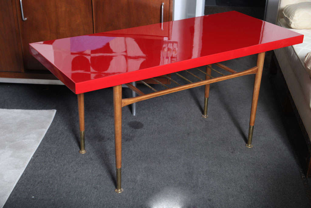 Beautiful 60's red top and natural legs sofa  table ... also perfect for flat screen TV and DVR....Brass accents at base of legs