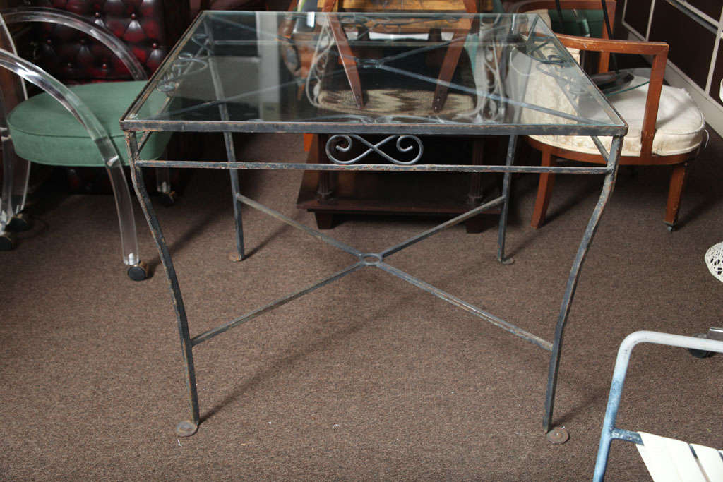 This table has a beautiful black iron base.... a shabby chic accent for an outdoor area with character