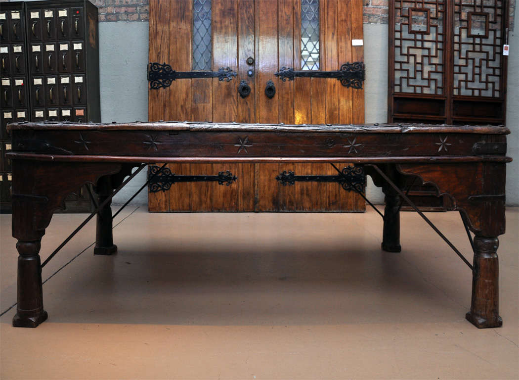 Wood and iron table from India with a fabulous patina, carved stars along the apron and carved scalloped spandrels.
 