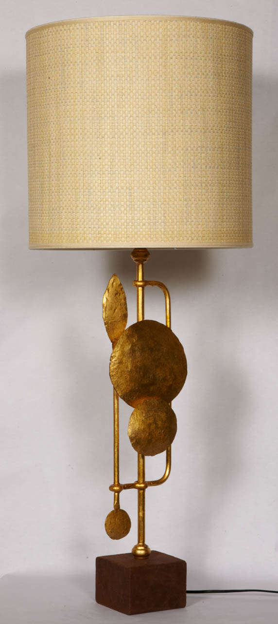 Pait of gilt wrought iron lamps on leather base