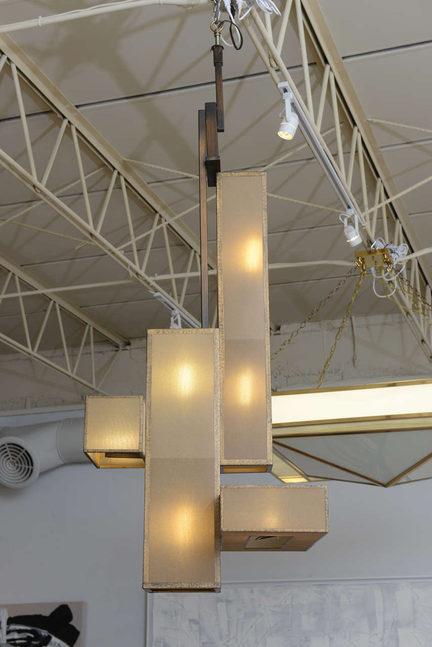 Large Italian modern patinated brass and glass chandelier of geometric form.